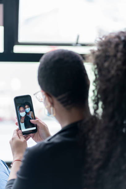 istock Two African female coworkers take a selfie inside the office 1328348265