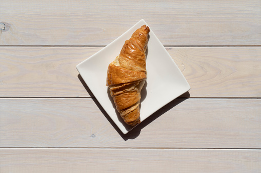 Freshly baked croissant on wood