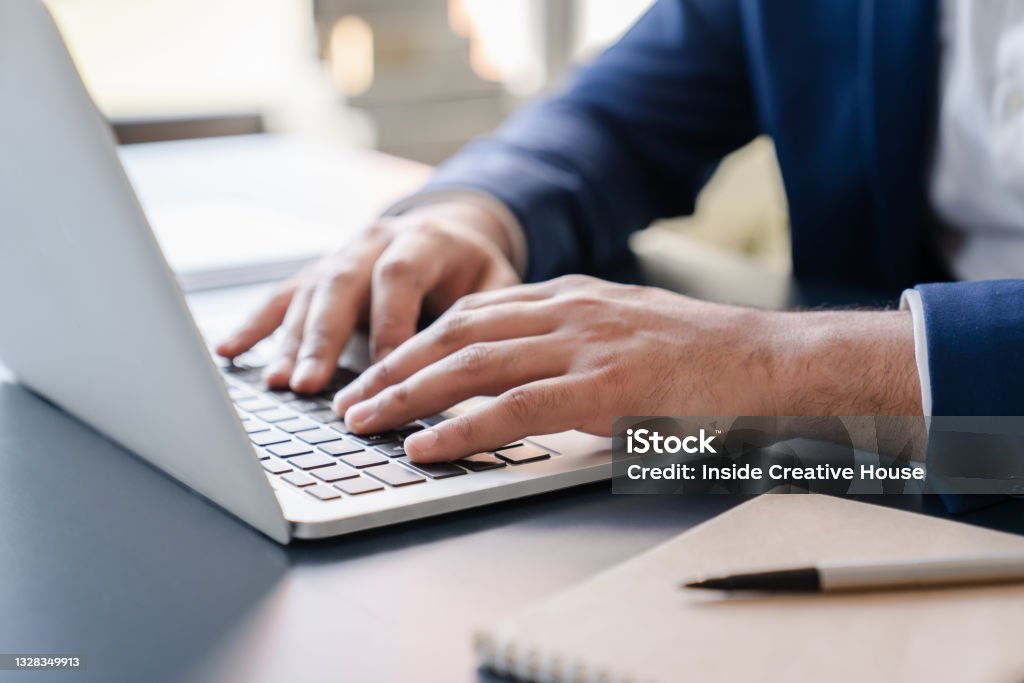 Cropped close up image of businessman`s hands typing working on laptop at home office. Freelancer, remote occupation,tutor, student e-learning concept Typing Stock Photo