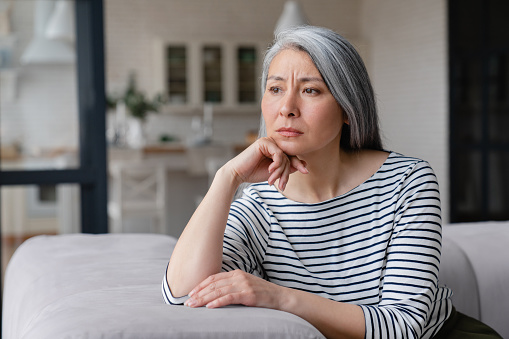istock Sad depressed tired lonely divorced ill mother mature woman feeling unwell, unhealthy, suffering from midlife crisis on lockdown, social distance 1328351657