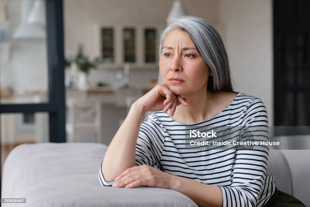 Sad depressed tired lonely divorced ill mother mature woman feeling unwell, unhealthy, suffering from midlife crisis on lockdown, social distance One Woman Only Stock Photo