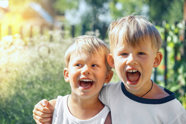 istock Joyful brothers scream hugging in summerhouse sunny yard 1328353317