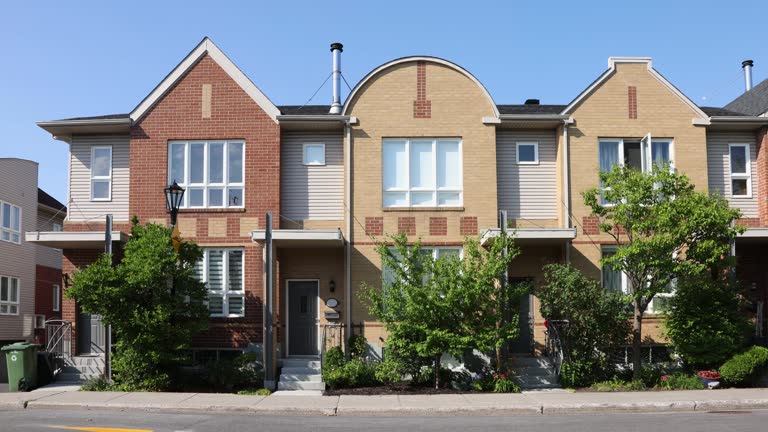 Front view of Montreal modern townhouses in a row during a sunset July evening