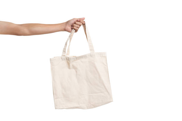 istock Hand man holding bag canvas fabric blank for mockup isolated on white background. with clipping path 1328355949