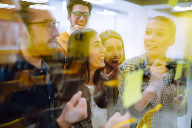 istock Sharing ideas concepts with papernote writing strategy on wall glass office. 1328357802