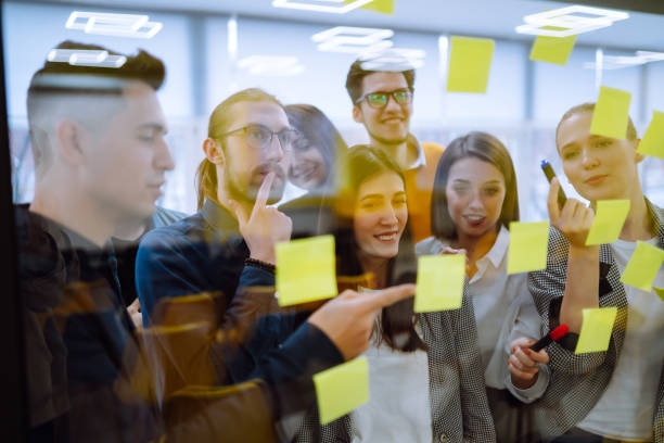 istock Sharing ideas concepts with papernote writing strategy on wall glass office. 1328357809