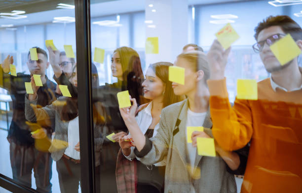 istock Sharing ideas concepts with papernote writing strategy on wall glass office. 1328357848