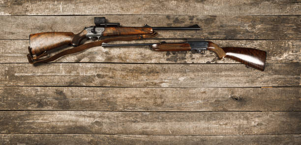 istock Hunting weapon on dark wooden backgorund, top view 1328358544