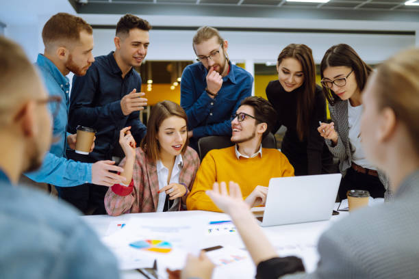 istock Successful team. Group of young businessmen working and communicating together in creative office. 1328359089