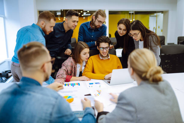 istock Successful team. Group of young businessmen working and communicating together in creative office. 1328359116