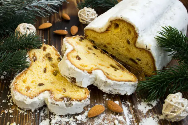 Traditional stollen and almond on the wooden background. Close-up.