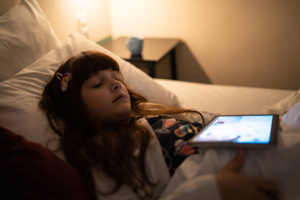 istock Exhausted girl sleeping using digital tablet at home 1328360233