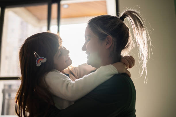 istock Mother and daughter embracing at home 1328360343
