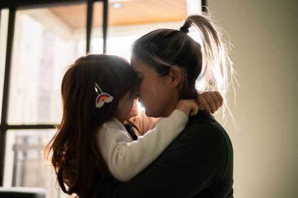 istock Mother and daughter embracing at home 1328360491