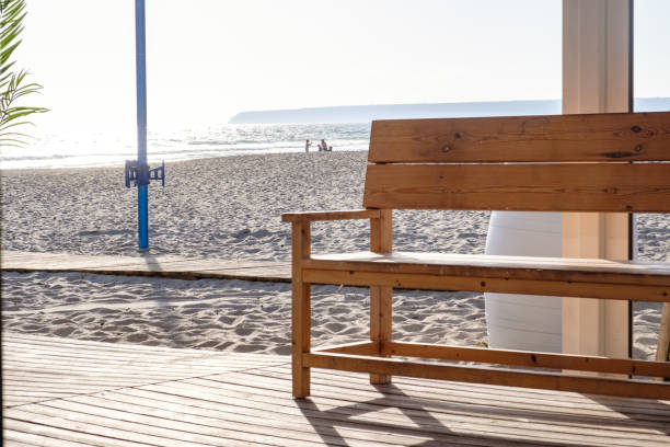 Wooden bench on beach by the sea