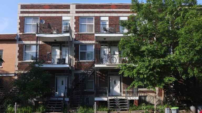 Row of classical Montreal Rosemont apartment buildings with exterior stairways in Summer