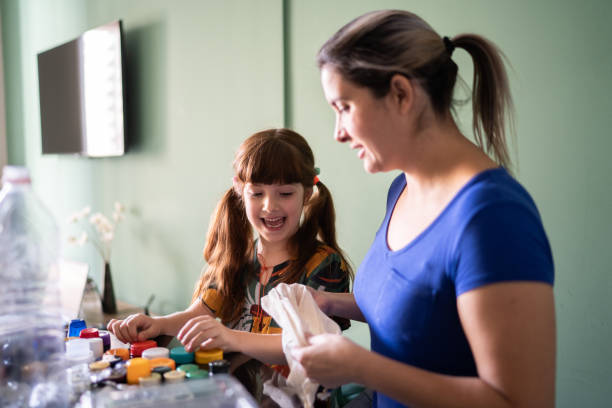 istock Mother and daughter separating reclying material at home 1328364346