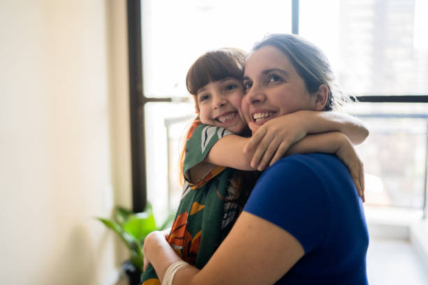 istock Mother and daughter embracing at home 1328364447