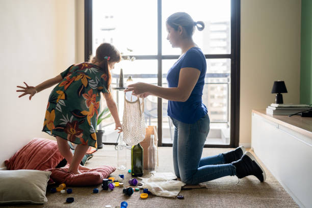istock Mother and daughter separating reclying material at home 1328364462