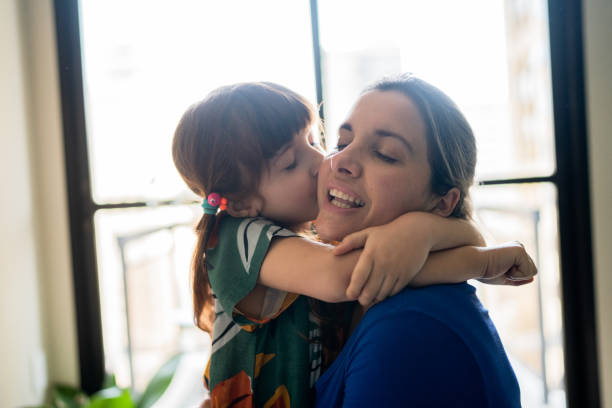 istock Mother and daughter embracing at home 1328364514