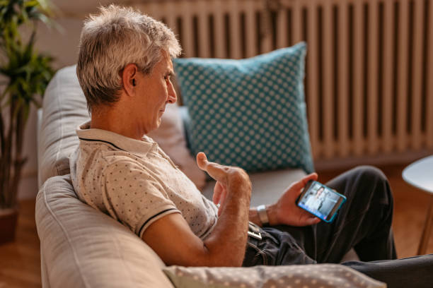istock Man Video Conferencing With Doctor On phone 1328364624