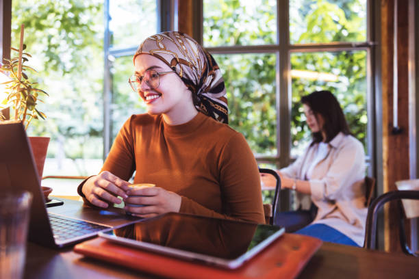 istock Hijabi influencer video conferencing from a cafe 1328367055