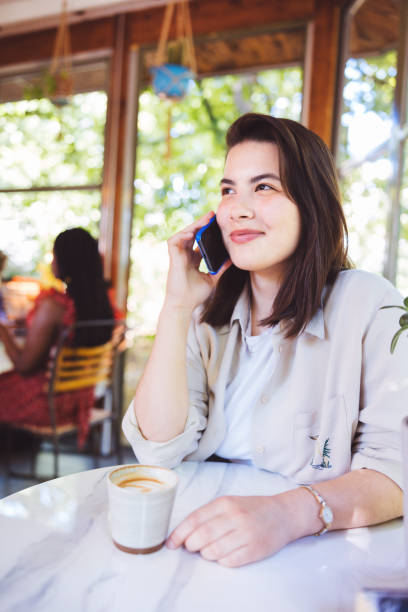 istock Girl at a Coffee Shop 1328367189