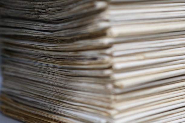 istock Close up corner of old newspapers folded stacked 1328367234