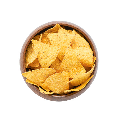 Corn tortilla chips in wooden bowl isolated over white background with clipping path. Top view