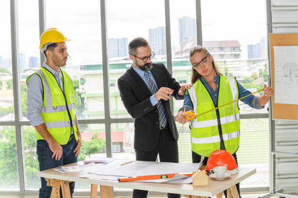 istock Engineers team meeting for architectural project. architects discussing blueprint with construction manager in office worker conference site. Construction Concept 1328367637