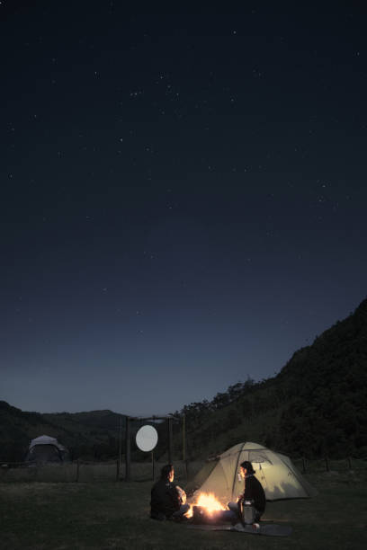 istock two young men camping under the stars 1328368212