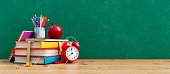 istock Ready for school concept background with books, alarm clock and accessory 1328368631