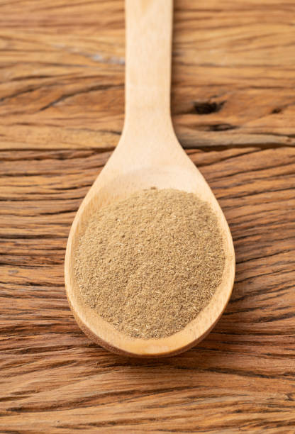 istock Closeup of ground cumin on a spoon over wooden table 1328369610