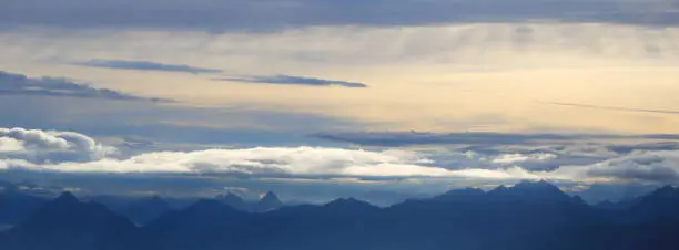 Morning scene seen from Mount Brienzer Rothorn, Switzerland. Clouds and colorful sky over mountain ranges.
