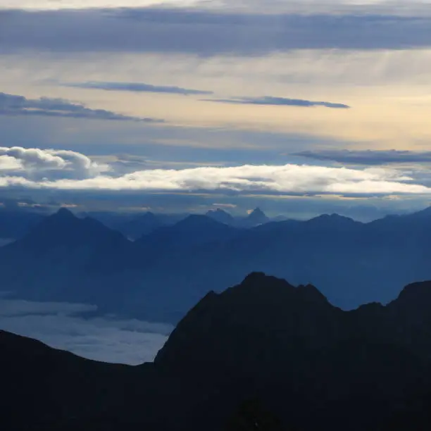 Morning scene seen from Mount Brienzer Rothorn, Switzerland. Clouds and colorful sky over mountain ranges.