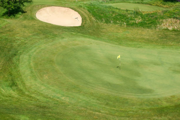 istock Green grass and holes on the golf course. 1328371062