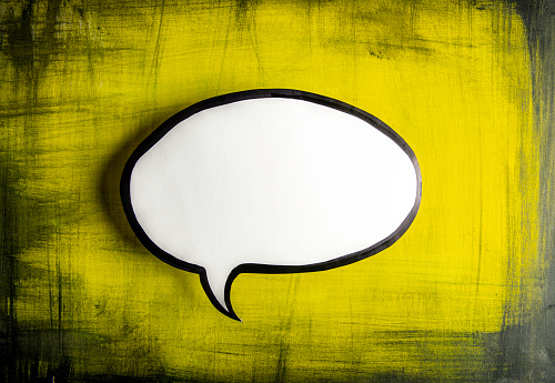 White chat bubble on yellow background.