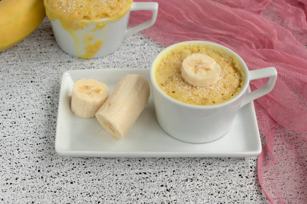 istock cupcake in a mug with banana pieces. Banana cupcake on a light background. 1328373268