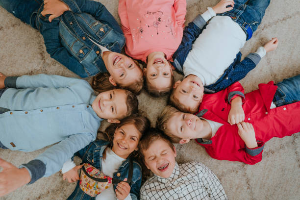 istock Friends lying on the floor looking at camera 1328374297