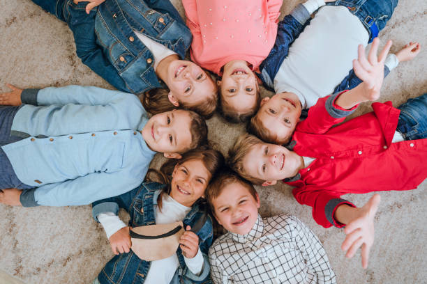 istock Friends lying on the floor looking at camera 1328374303