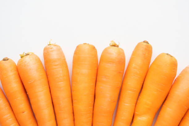 istock Ripe carrots on a light background, top view, not isolated 1328376675