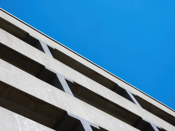 istock Facade of a multi-level car parking on a background of blue sky 1328377732