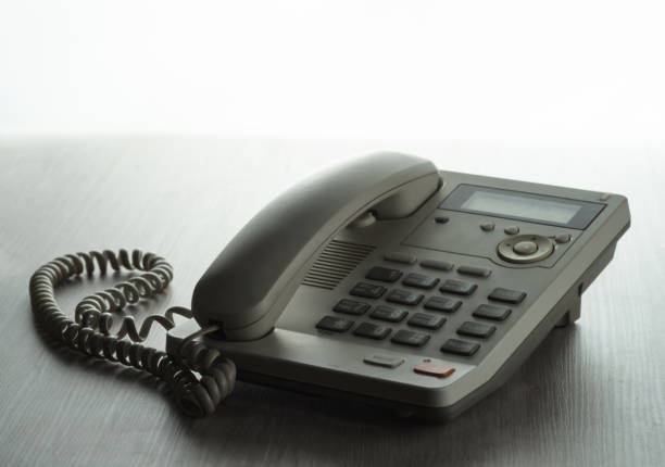 istock Landline phone with buttons on the table. On a white background. 1328377804