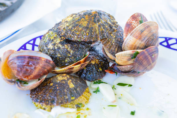 istock Limpets and Clams shells in finished dish - fried with Garlic and Parsley - Lanzarote's typical dish from Canary Islands 1328378097