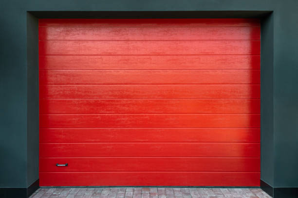 New bright red garage door elevation close up. Entrance to the garage. New bright red garage door elevation close up. Entrance to the garage door panel stock pictures, royalty-free photos & images