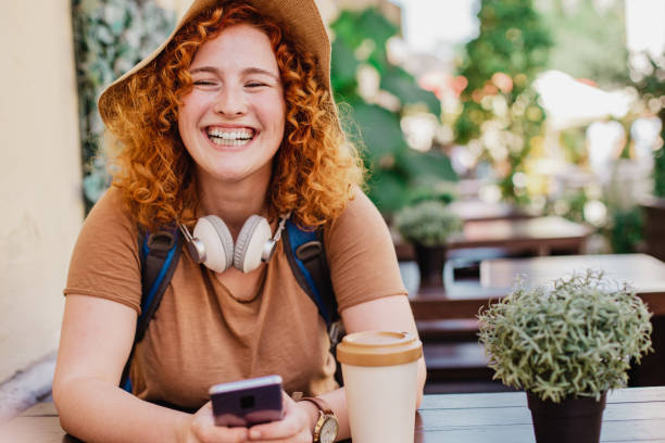 istock Female tourist with backpack relaxing and using mobile phone 1328380385