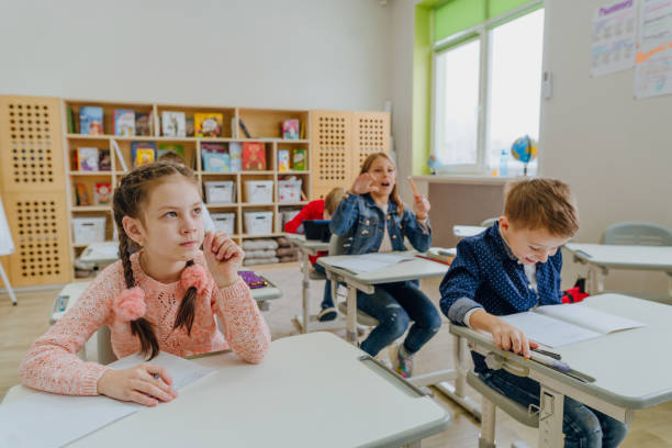 istock Pupils wearing casual clothes solving exercise in the classroom 1328381642