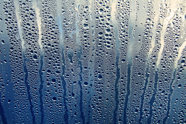 istock Texture of rain drops on a glass wet transparent surface. 1328383206