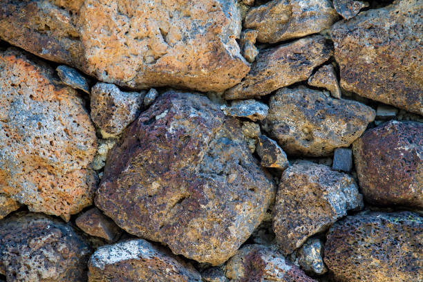 Stone wall made up of small and large rocks creating a barrier
