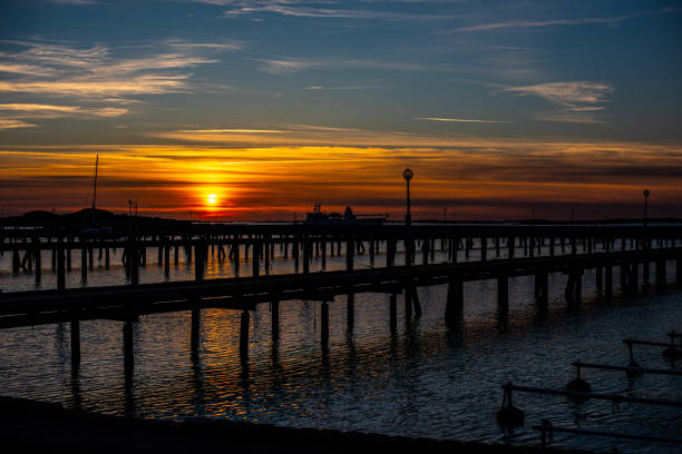 istock Sunset behind empty wooden piers.. 1328386064